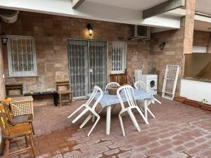 a patio with a table and chairs on a brick patio at Aurelia Antica ELLE Apartment in Rome