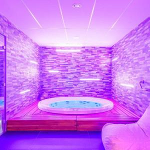 a bathroom with a large bath tub in a room at Gite de Amiens Poulainville in Poulainville