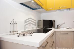 a kitchen with a sink and a microwave at Suites Marilia Apartments - Suite Livorno Holiday Home Group in Livorno