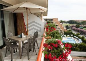 a balcony with a table and chairs and an umbrella at Suites Marilia Apartments - Suite Livorno Holiday Home Group in Livorno