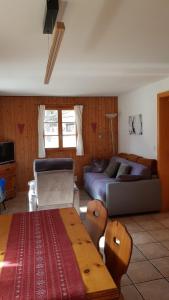 a living room with a couch and a table at Chalet Sonnenblick in Fiesch