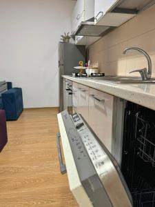 a kitchen with a sink and a counter top at Sunset Apartment in Tirana