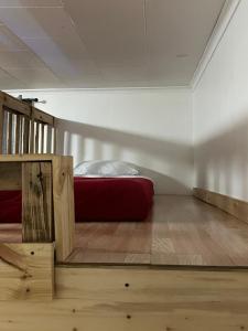 a bedroom with a bed and a red mattress at 1892 historical apartments in Mountain Iron