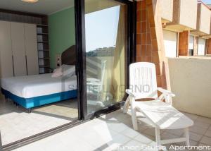 a bedroom with a bed and a chair and a window at Suites Marilia Apartments - Suite Livorno Holiday Home Group in Livorno