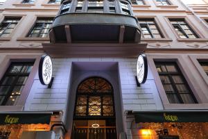 a building with two clocks on top of it at Elmira Pera Hotel & - Special Class in Istanbul