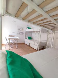 a room with two bunk beds and a table at Racing Mackerel Hostel in Lagos