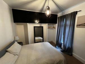 a bedroom with a large white bed and a window at Cityscape-Cosy House By Anfield in Liverpool