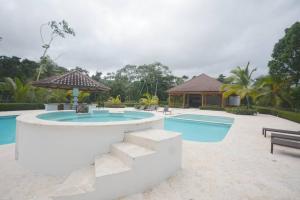 a swimming pool with a gazebo next to at Magnifique appartement vue mer in Las Terrenas