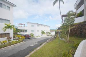 a street in front of a white building at Magnifique appartement vue mer in Las Terrenas
