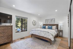 a white bedroom with a bed and a window at Fun & Air Conditioned Lake Tahoe 3 BR/2.5 BA Home in Incline Village