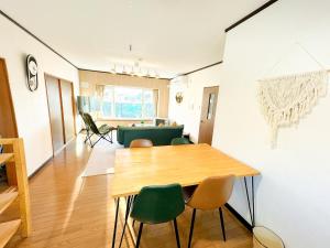 a dining room with a table and chairs at Kaito/9min walk to Noboribetsu st. in Tomiura