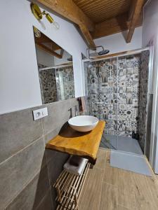 a bathroom with a sink on a wooden table at La Cochorla in Páramo del Sil +36 photos