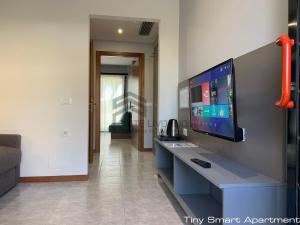 an office with a blue desk with a tv on it at Suites Marilia Apartments - Suite Livorno Holiday Home Group in Livorno