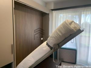 a bed in a room next to a window at Suites Marilia Apartments - Suite Livorno Holiday Home Group in Livorno