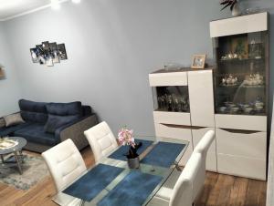 a living room with a table and a couch at Apartament u Bączków in Gdynia