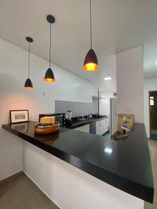 a large kitchen with a black counter top at Casa Amoreira in Paraty