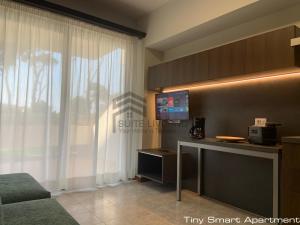 a living room with a tv and a window at Suites Marilia Apartments - Suite Livorno Holiday Home Group in Livorno