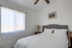 a bedroom with a white bed with a window at Entire First-Floor 3-Bedroom w Gated Yard, Laundry, Crib, Fast Wi-Fi, Private Rental, No Deposit in San Diego
