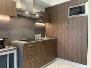 a kitchen with wooden cabinets and a sink at Suites Marilia Apartments - Suite Livorno Holiday Home Group in Livorno