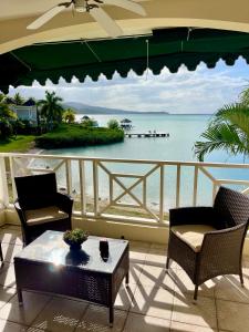 a balcony with a view of the ocean at Luxury Apartments and Rooms,The Lagoons in Montego Bay