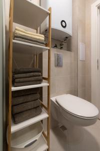 a bathroom with a towel rack next to a toilet at Apartment KALINA with free private parking in Plovdiv