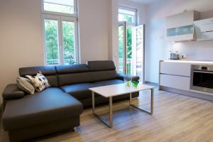 a living room with a couch and a table at Altstadt Appartements Goslar in Goslar