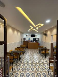 a dining room with tables and chairs in a restaurant at Deepakam Inn in Palakkad