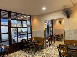 a dining room with tables and chairs in a restaurant at Hotel Deepakam Inn in Palakkad