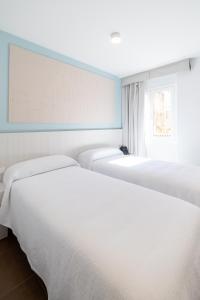 Postel nebo postele na pokoji v ubytování Hotel Alkazar