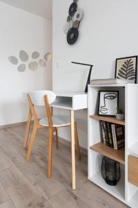 a desk and chair next to a book shelf at Apartment KALINA with free private parking in Plovdiv