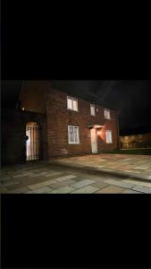 a large brick building with a door on a street at The Highfield Chester. in Chester