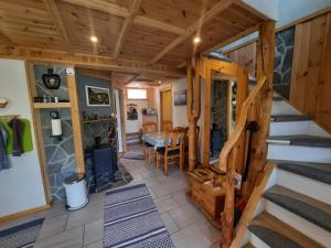 a room with stairs and a dining room with a table at Fjordgaestehaus in Innfjorden