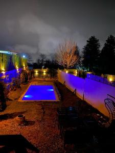 a swimming pool lit up at night with lights at Twins bungalow in Sapanca