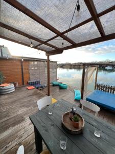 a patio with a table and chairs and a view of the water at Barbana Cottage in Ulcinj