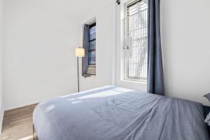 a bedroom with a bed and a window at Inspiring Urban Life, Times square Apartments in New York