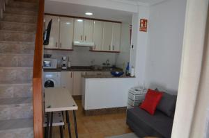 a small kitchen with a couch and a table at Casita Amalia in Santa Pola