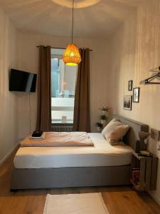 a bedroom with a bed with a window and a lamp at Augusta in Koblenz