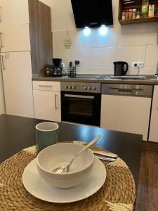 a kitchen with a bowl and a spoon on a table at Augusta in Koblenz