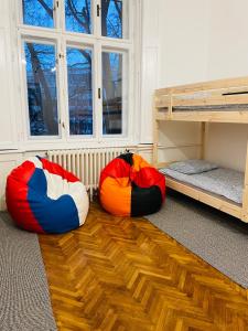 three bean bags sitting on the floor in a room at Hostel Green World in Novi Sad