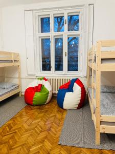 three bean bags sitting on the floor in front of a window at Hostel Green World in Novi Sad