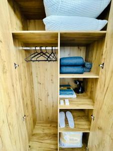 a wooden closet with a bed and some shelves at Altheda Living Avanera 9B-144 in Suceava