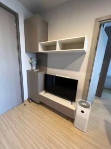 A television and/or entertainment centre at The Homey, 3 min walk to Sky train direct to CBD