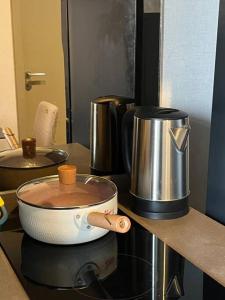 a pot of coffee sitting on a stove top at The Homey, 3 min walk to Sky train direct to CBD in Bangkok