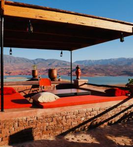 a bed on a patio with a view of the desert at House of dreams in bin el ouidane in Bine el Ouidane