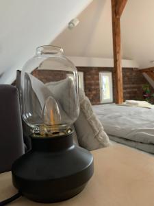 a glass trophy on a table in a bedroom at Apartamenty Astor - Księżycowy in Szczawno-Zdrój