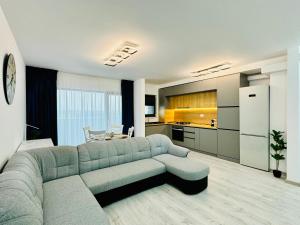 uma sala de estar com um sofá e uma cozinha em Altheda Living Avanera 9B-144 em Suceava