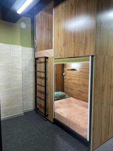 a room with a bunk bed in a room at KOCHEVNIK HOSTEL in Almaty