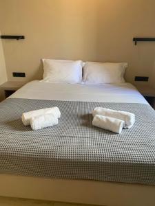 a bedroom with a bed with two towels on it at Traditional Cosy Home in Ios Chora