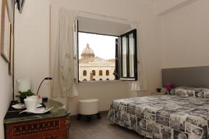 a bedroom with a window with a view of a building at Temple View in Rome