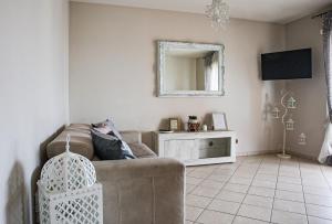 a living room with a couch and a mirror at Giramondo Guest house in Fiumicino